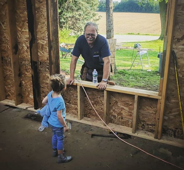 Richard Struck and granddaughter on the job site